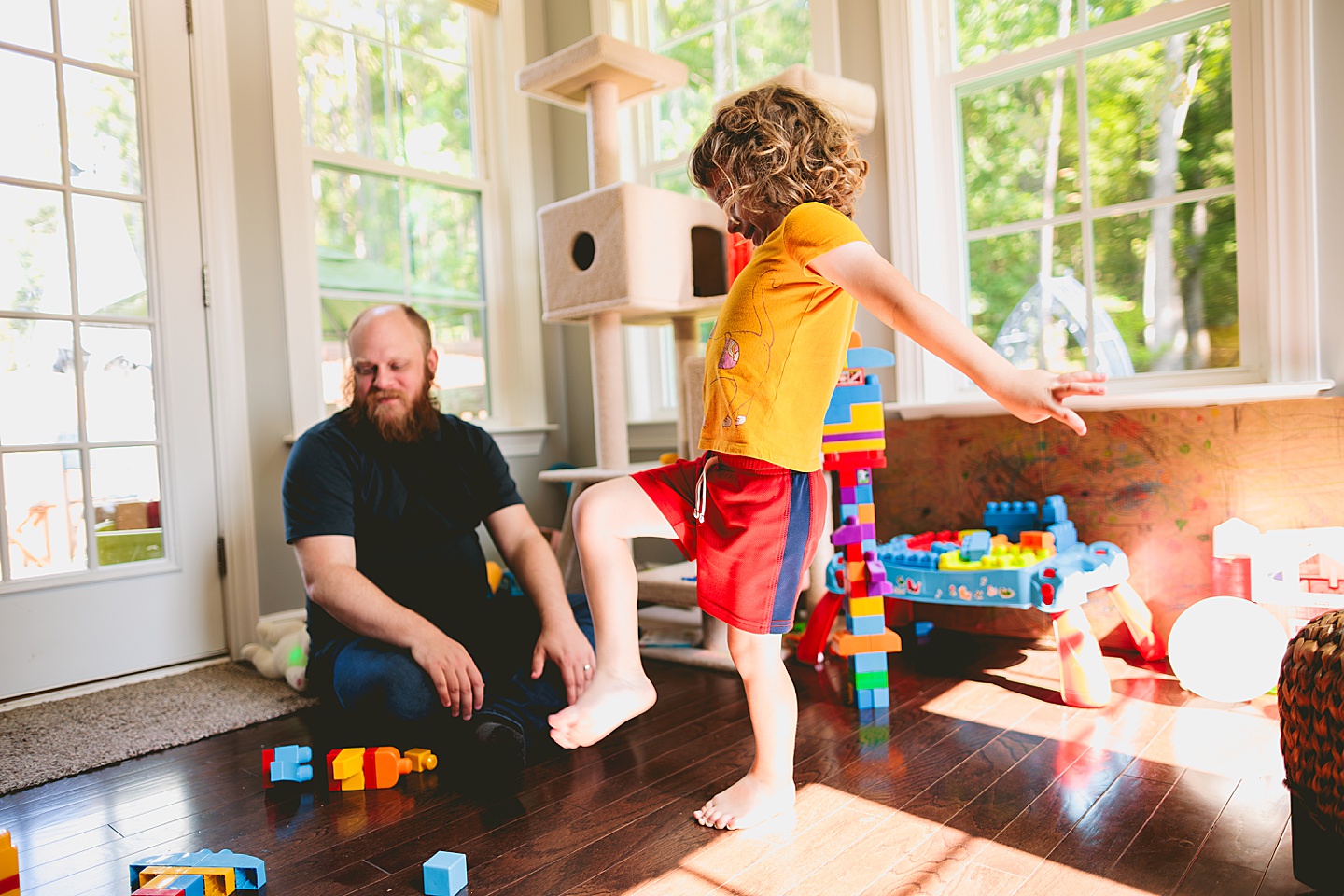 Family playing with blocks in sunroom