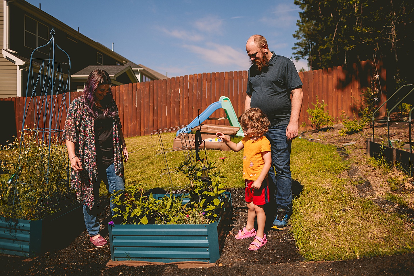 Family photos in Holly Springs of a family gardening in their backyard