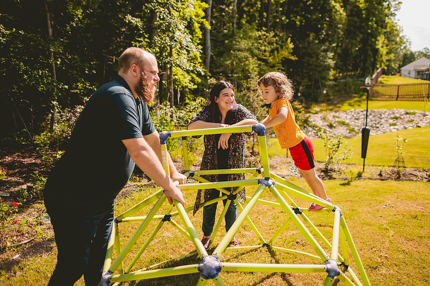 Child playing on jungle gym in backyard