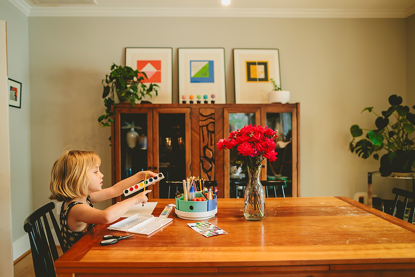 Kid painting in dining room