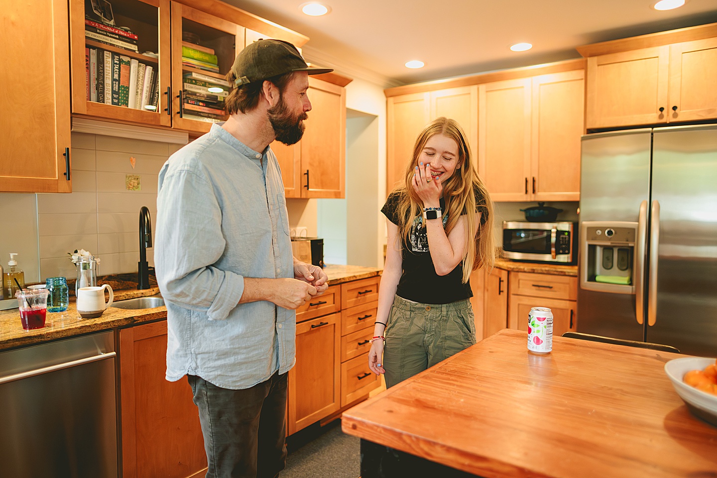 Father and daughter talking in kitchen