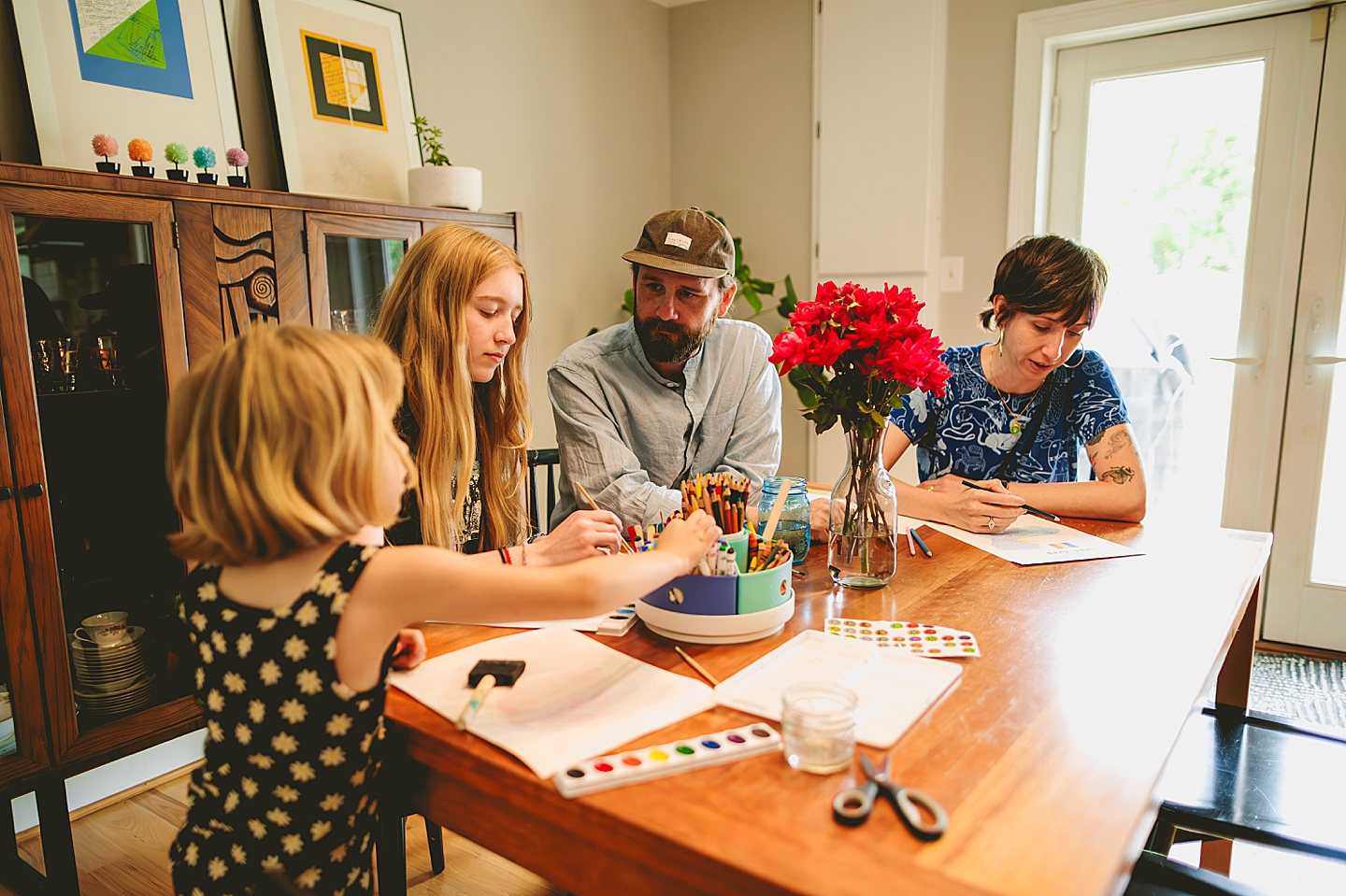 Family painting together in dining room