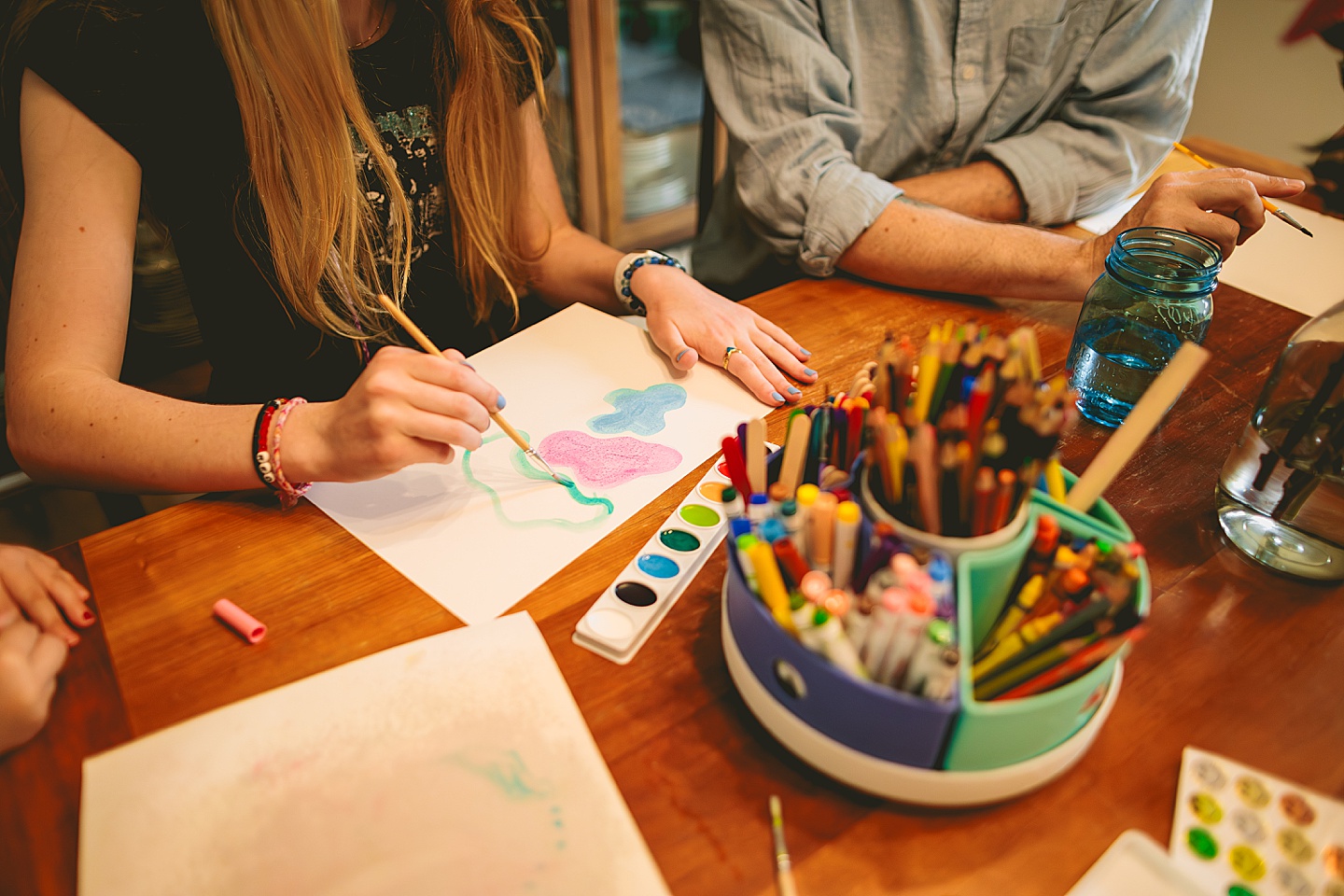 Family painting together in dining room