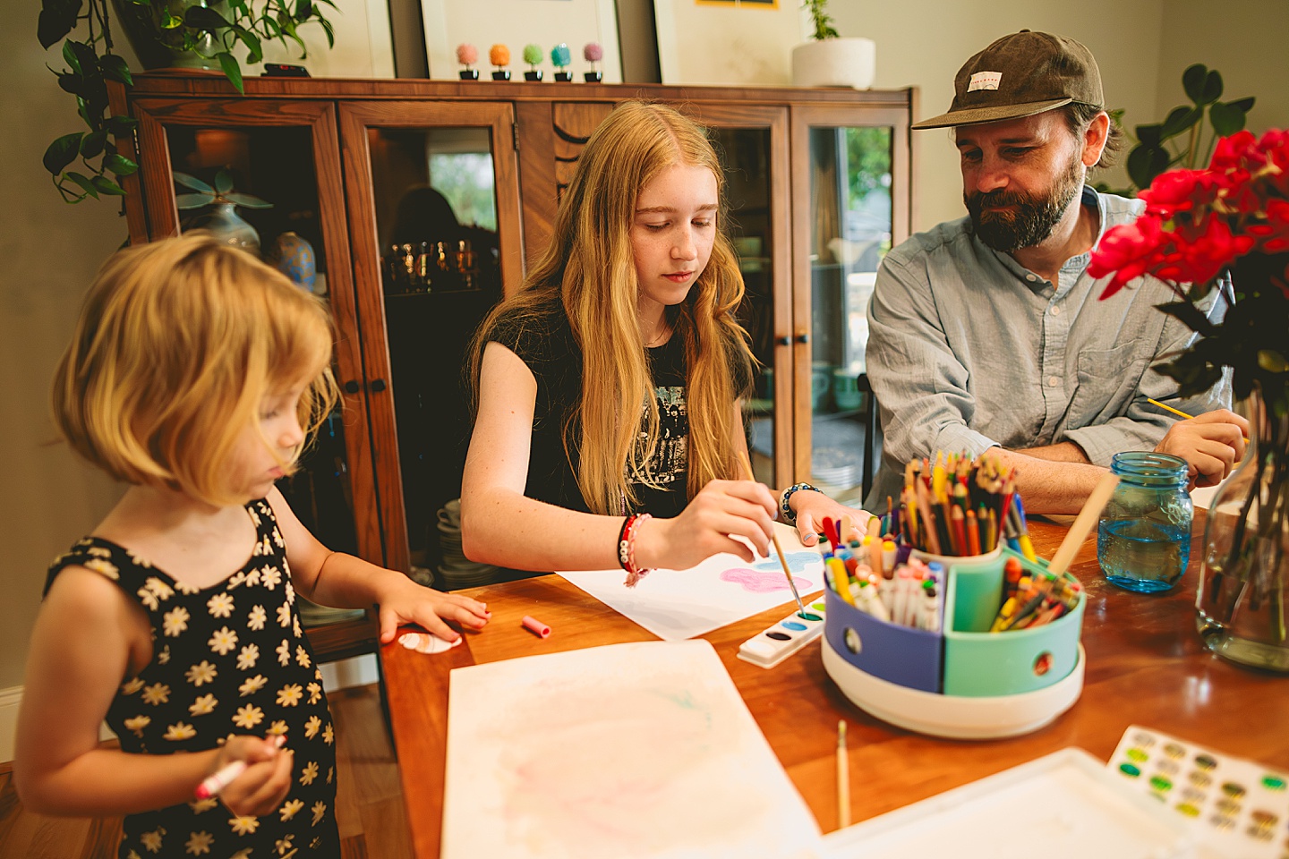 Family painting together in dining room