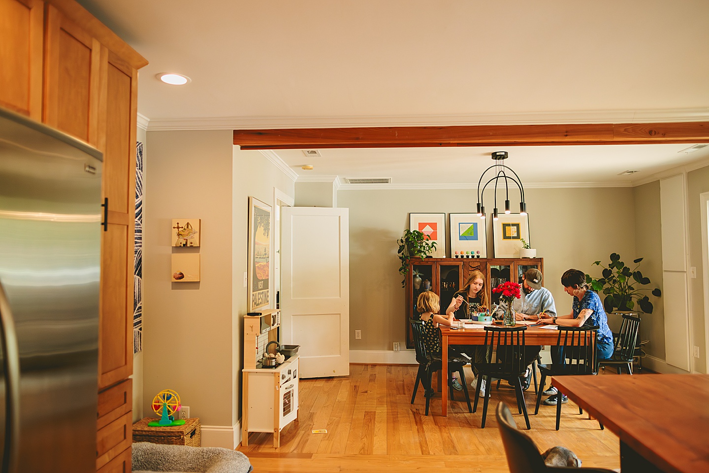 Family painting together in dining room