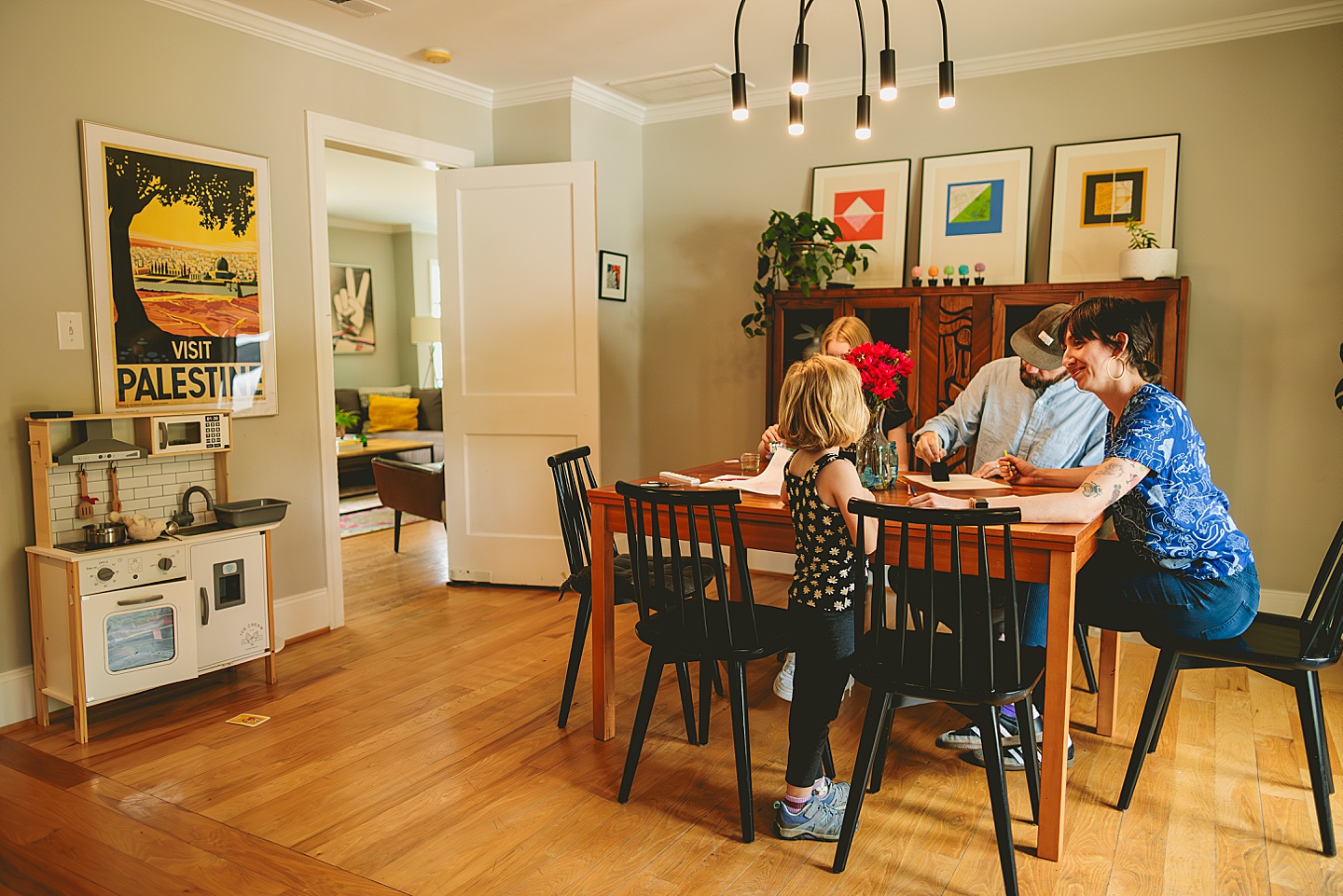 Family painting together in dining room