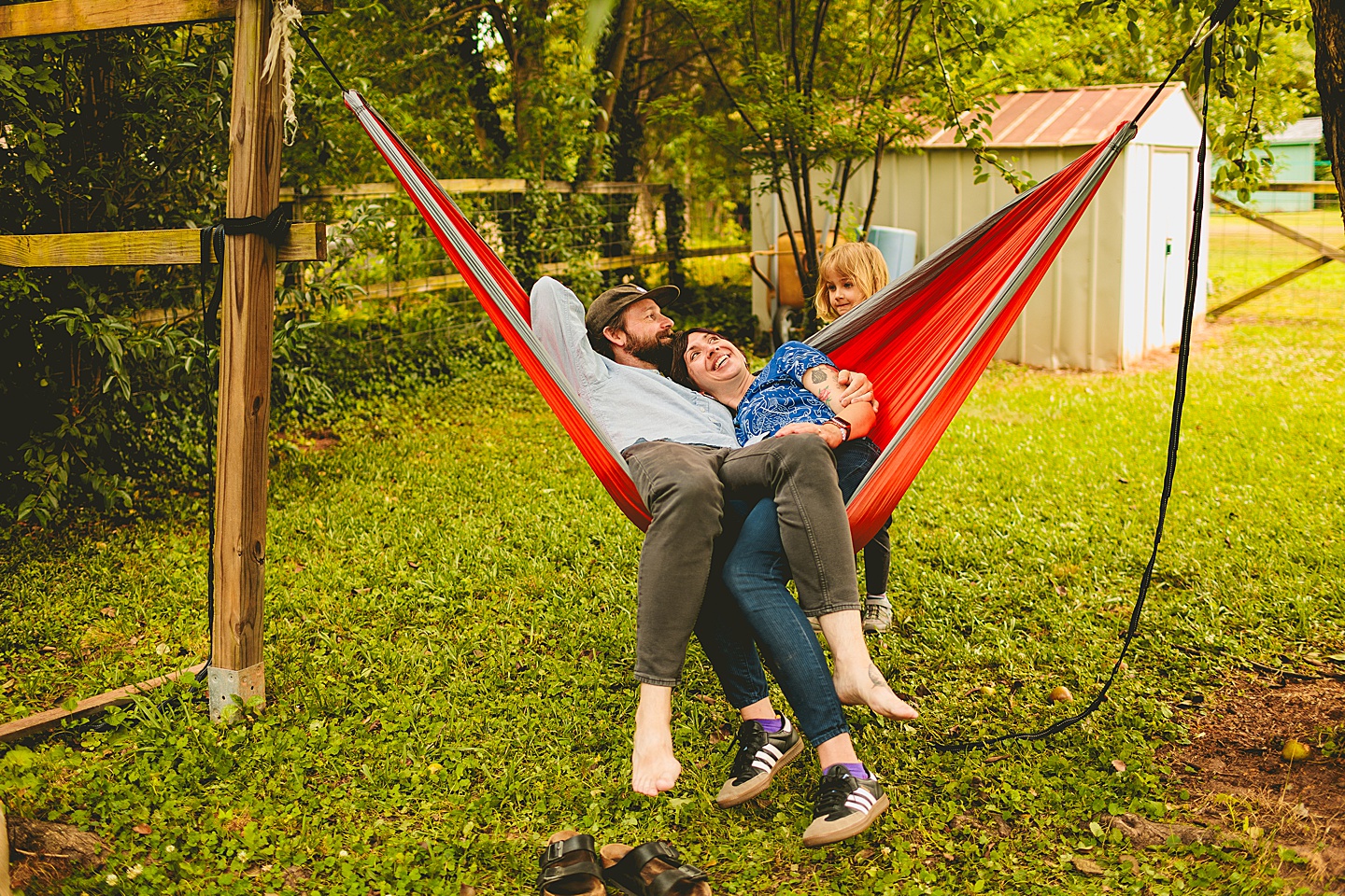 Parents in hammock while kid talks to them