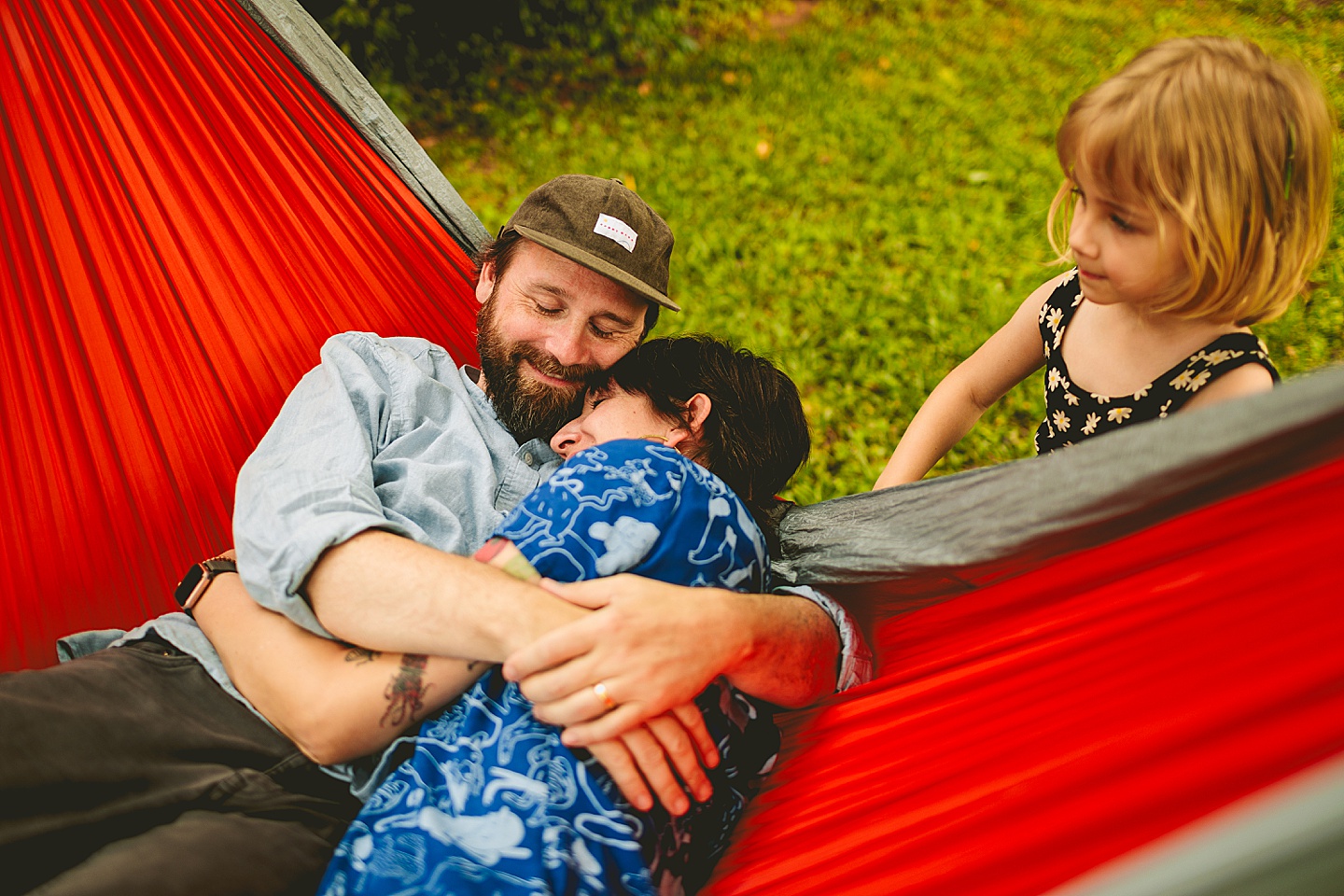 Parents in hammock while kid talks to them