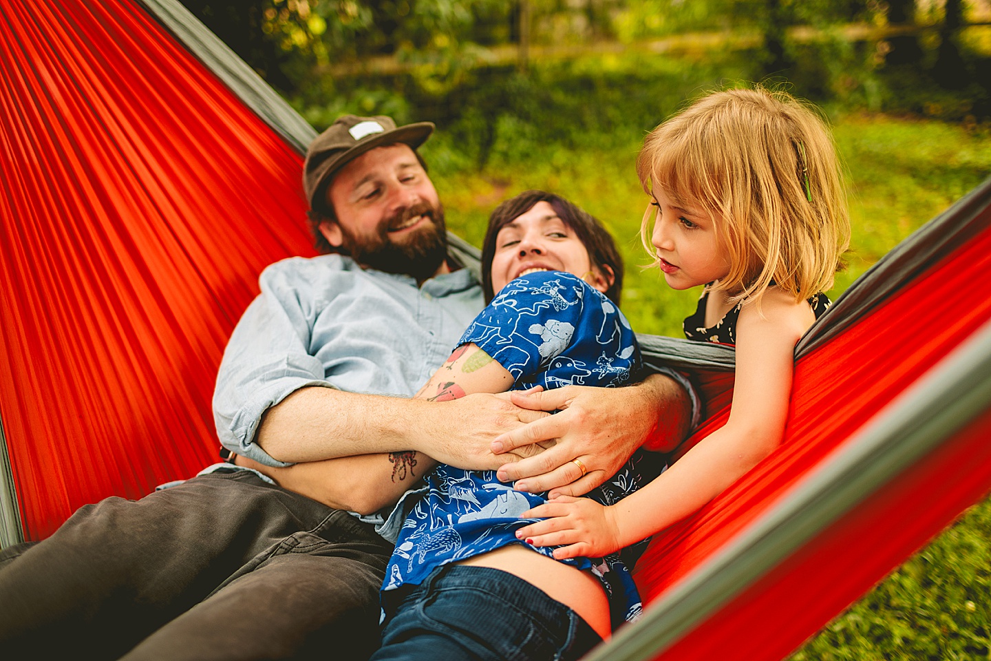 Parents in hammock while kid talks to them