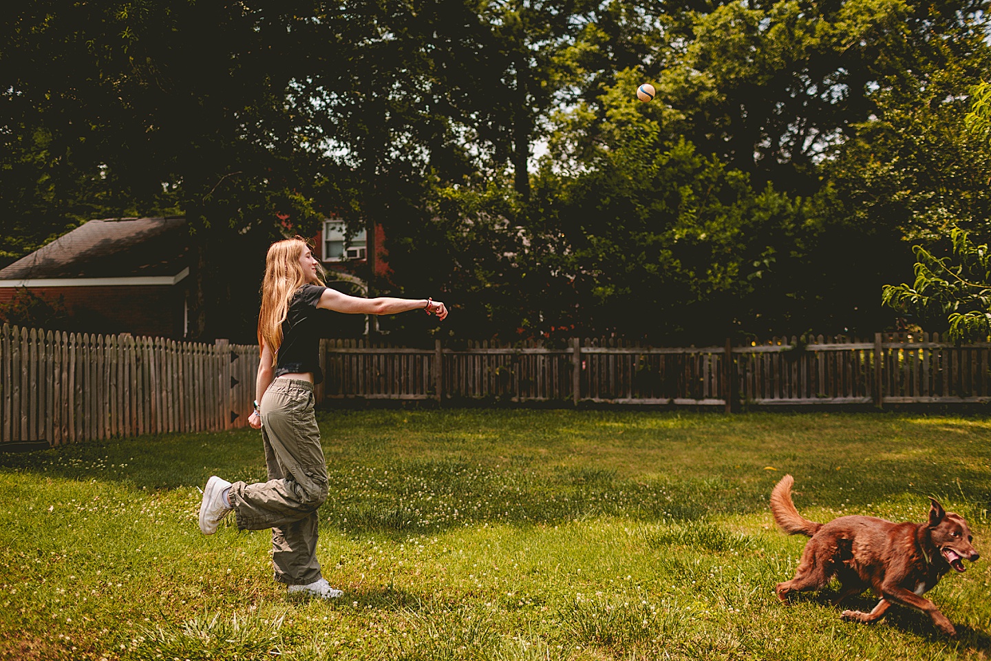 Girl playing fetch with dog
