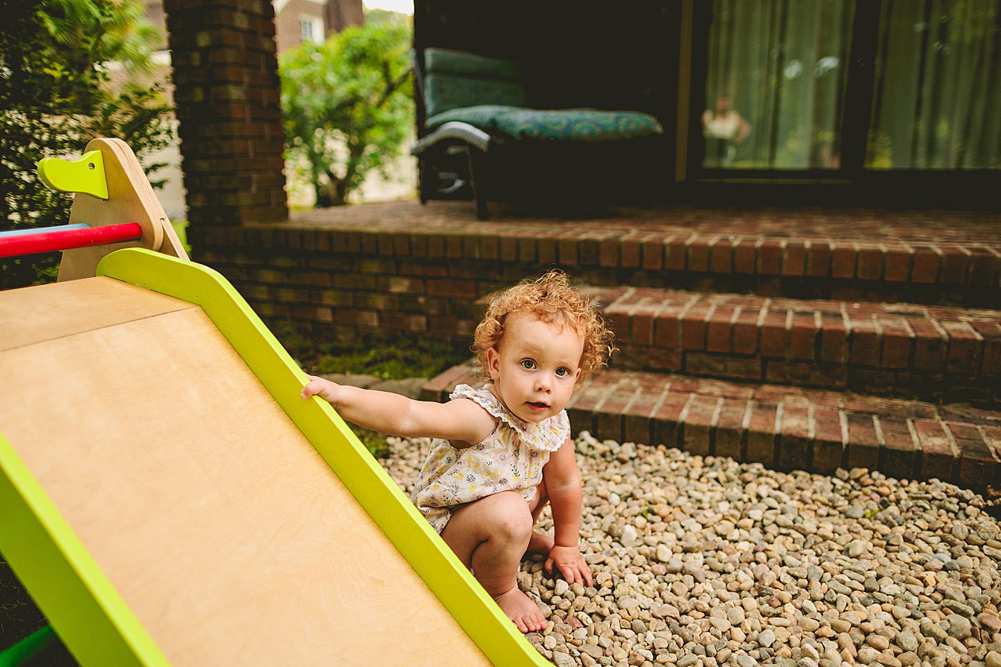 Toddler behind slide