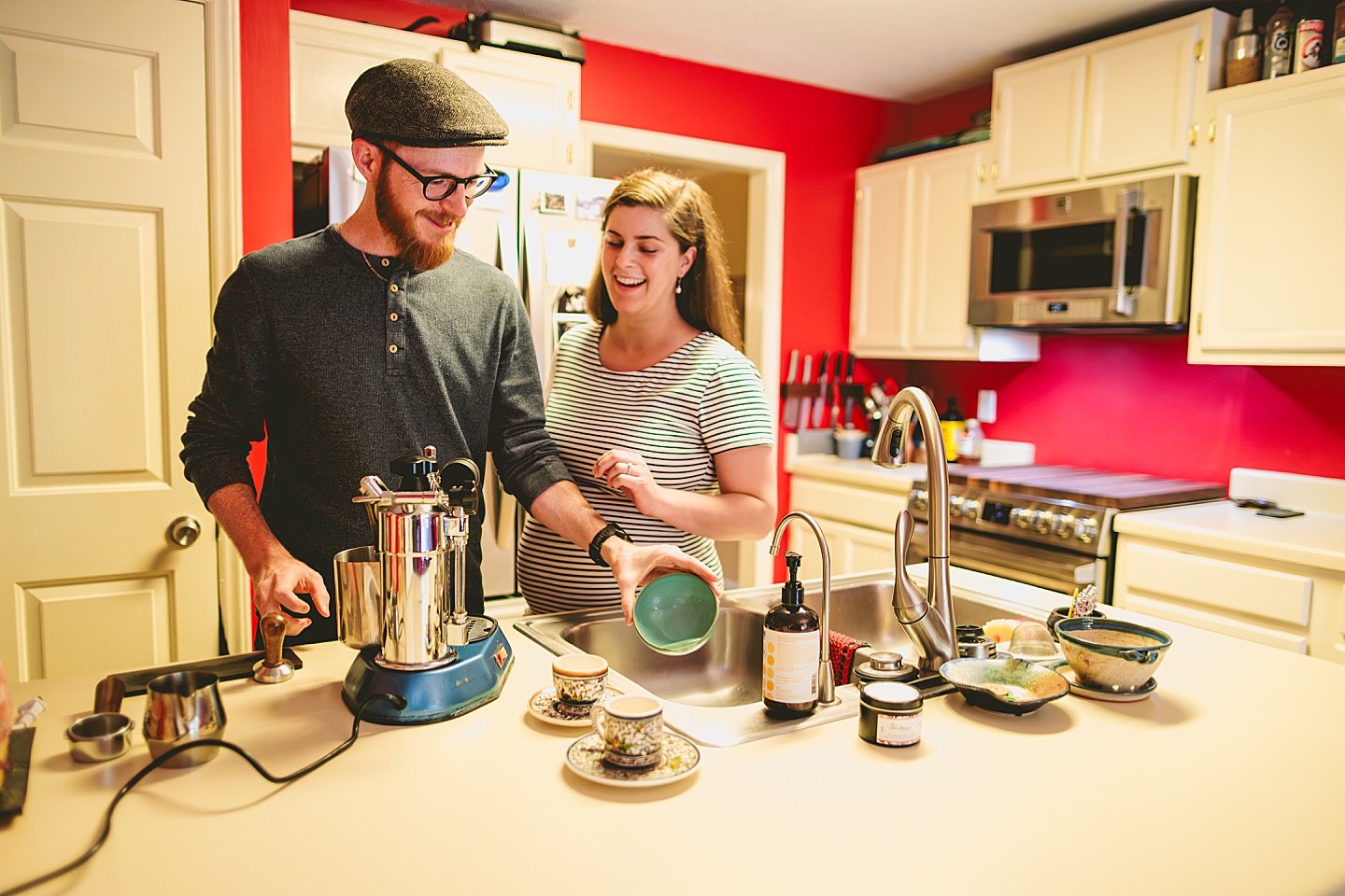 Couple making coffee in a red kitchen