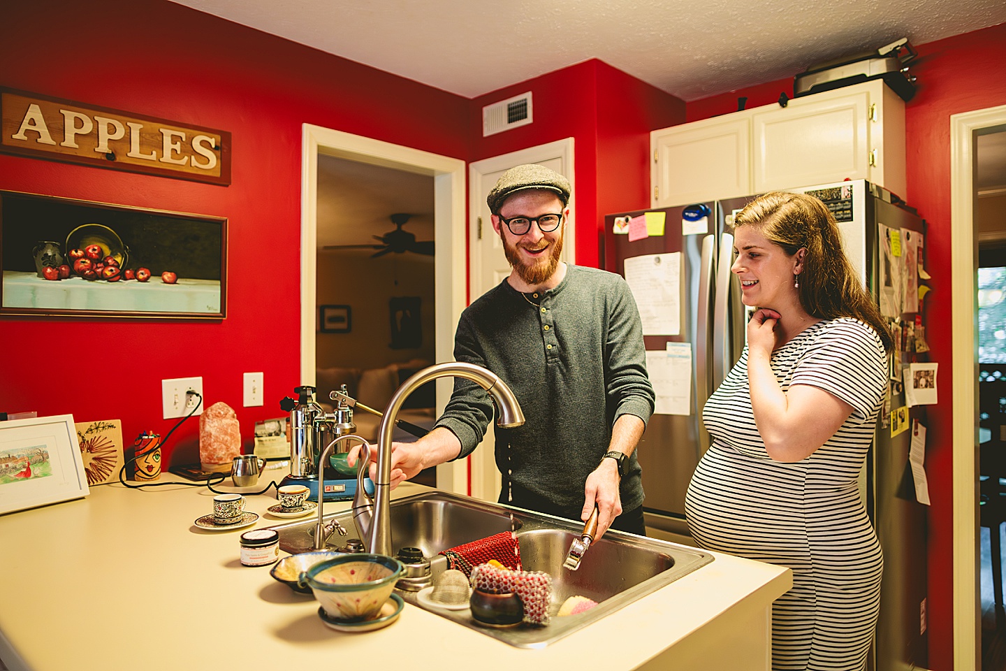 Couple making coffee in a red kitchen