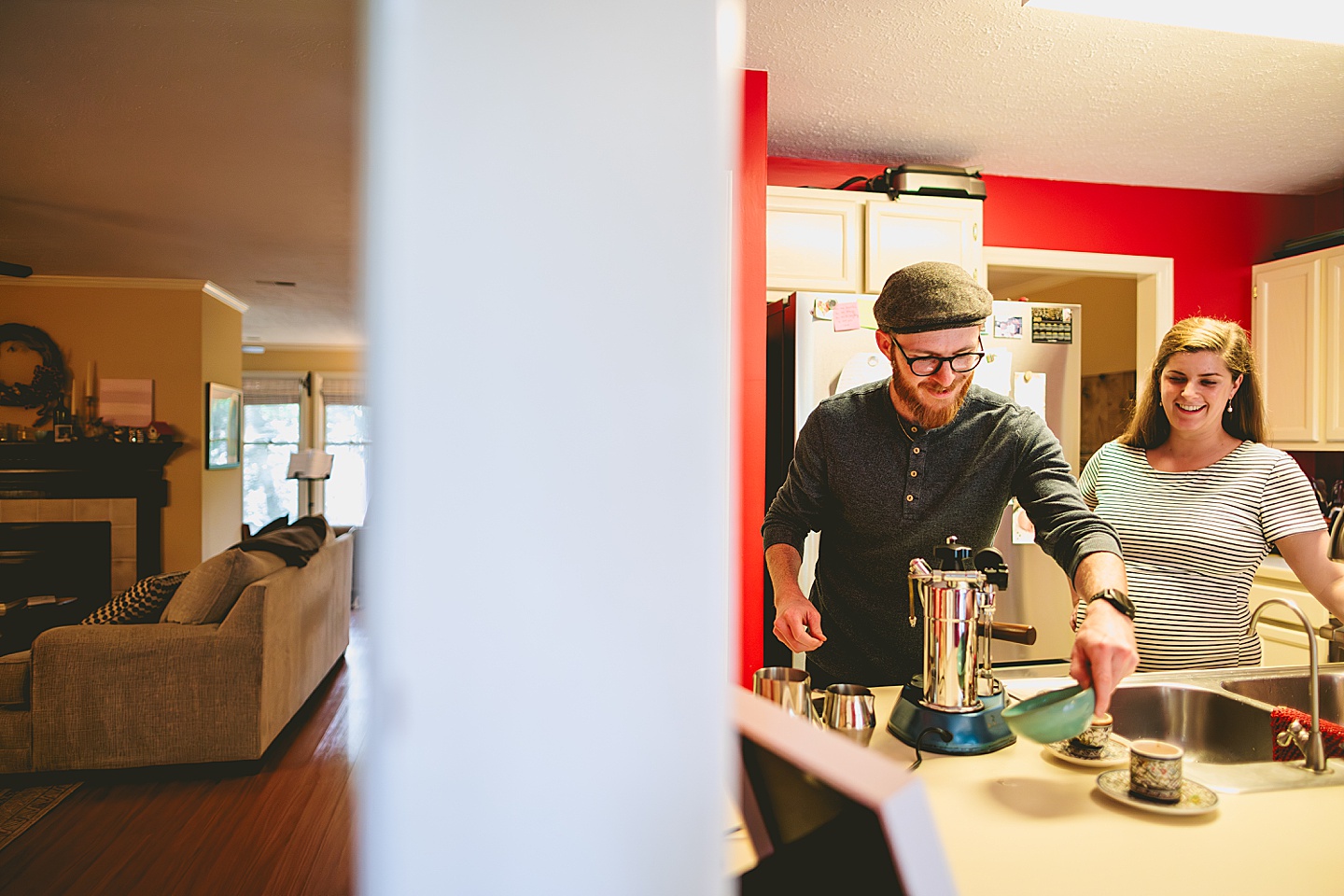 Couple making coffee in a red kitchen