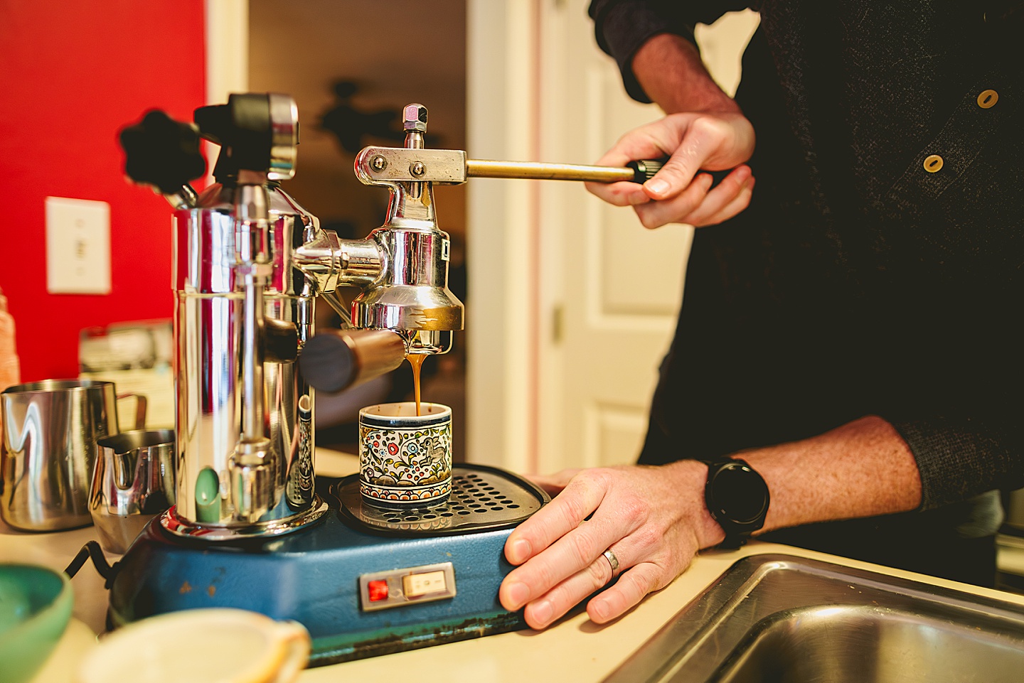 Couple making coffee in a red kitchen