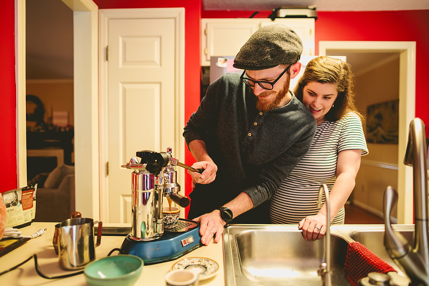 Couple making coffee in a red kitchen