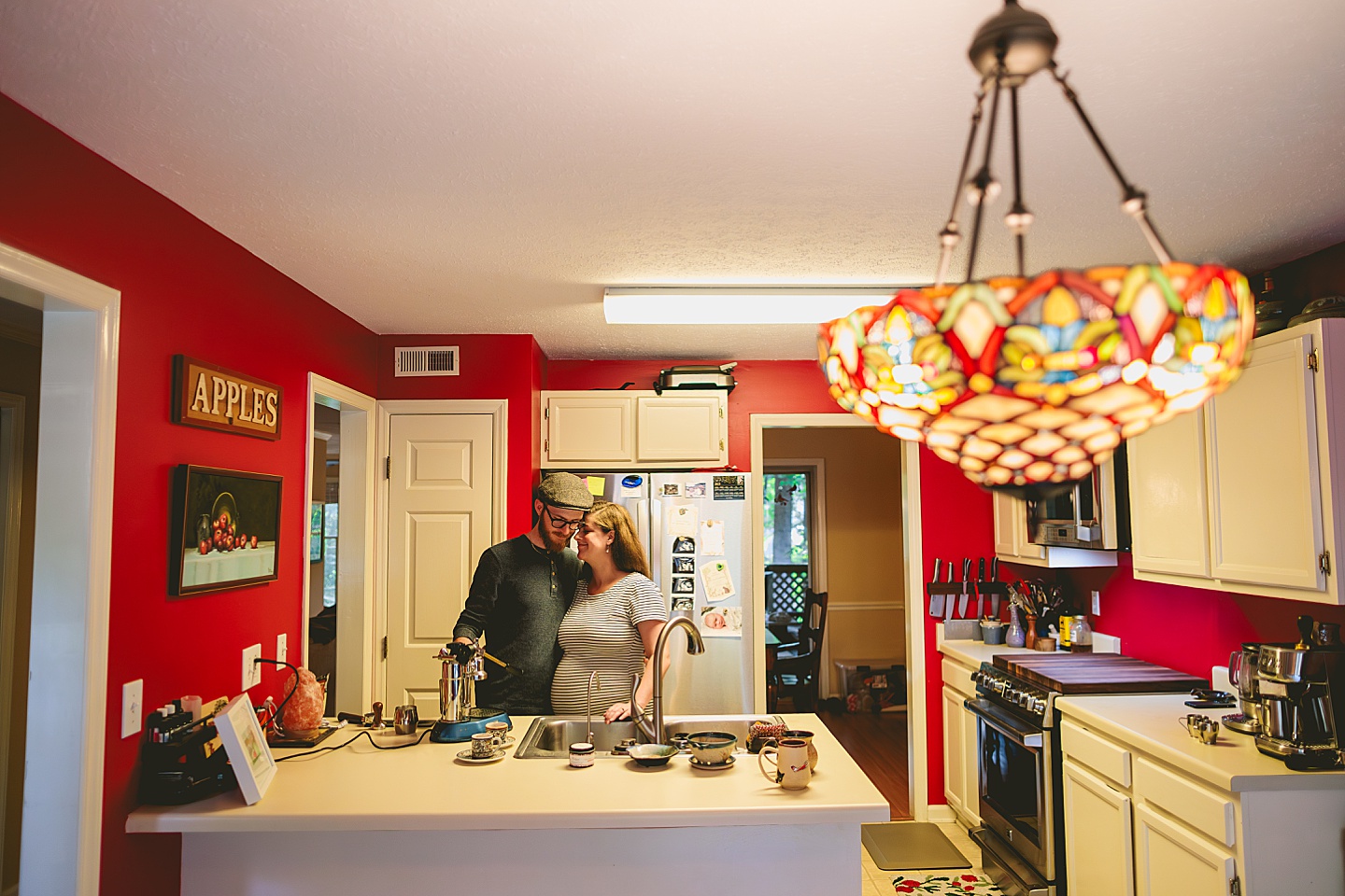 Couple making coffee in a red kitchen