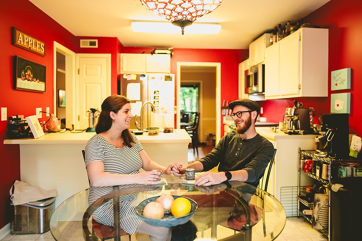 Couple making coffee in a red kitchen