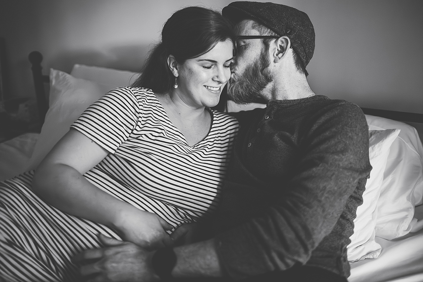 Couple cuddling on bed