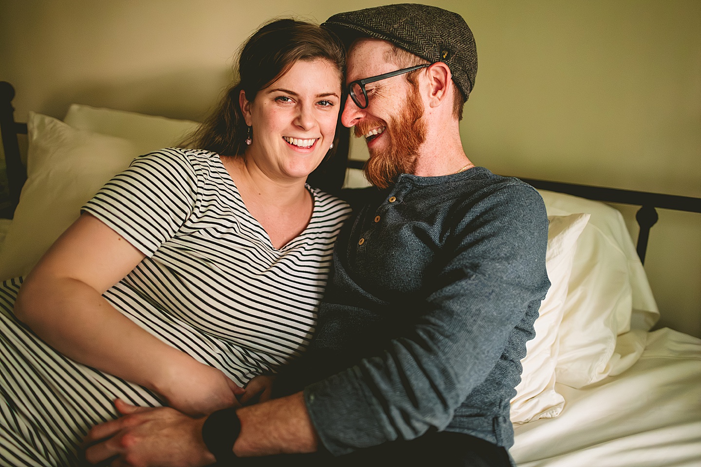 Couple cuddling on bed