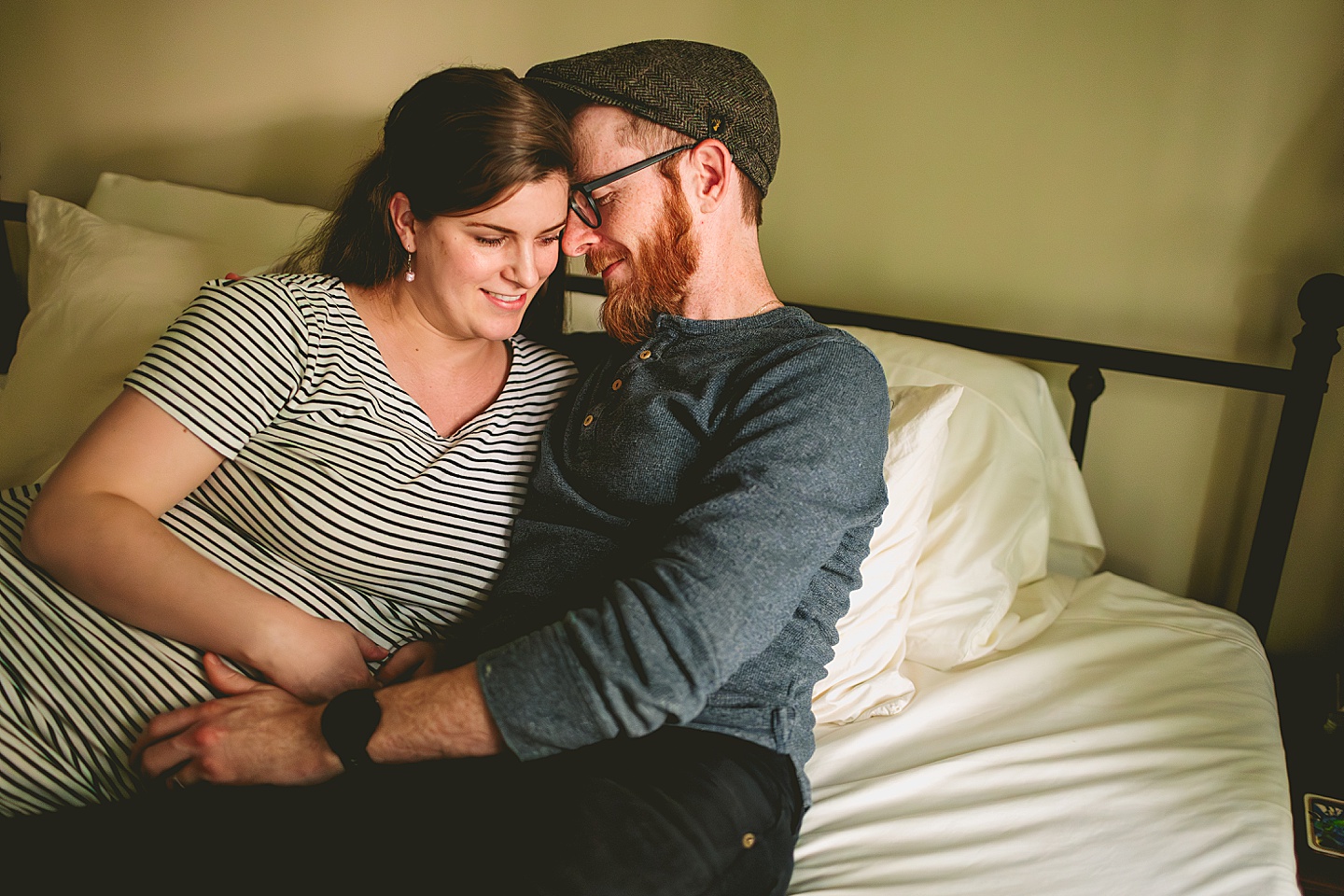 Couple cuddling on bed