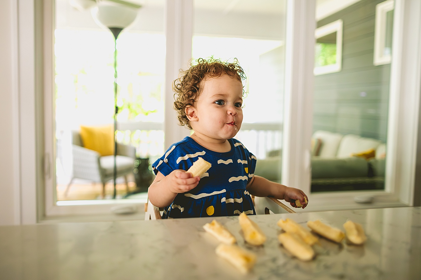 Mom feeding bananas to baby as lunch snack