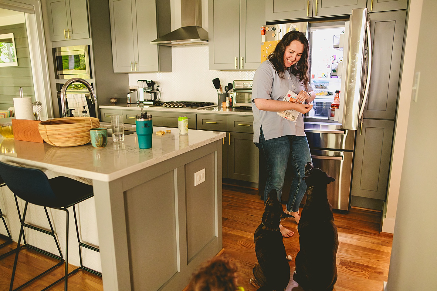 Woman getting cheese out of the fridge to feed dogs