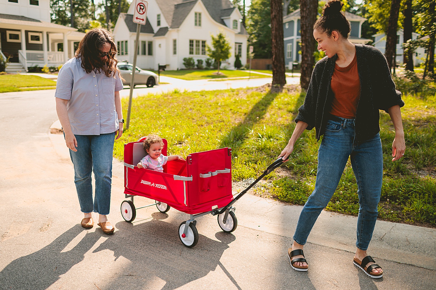 Baby riding in red wagon