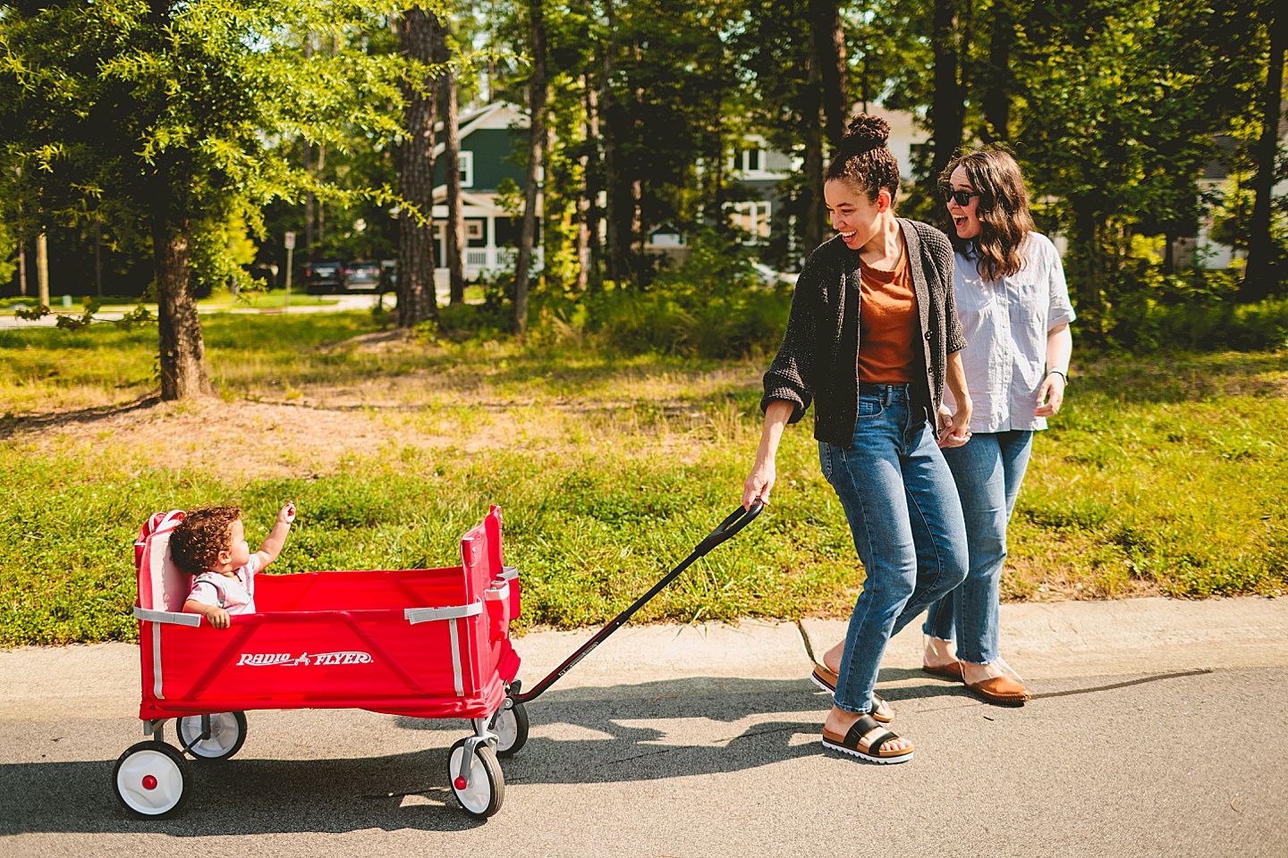 Baby riding in red wagon