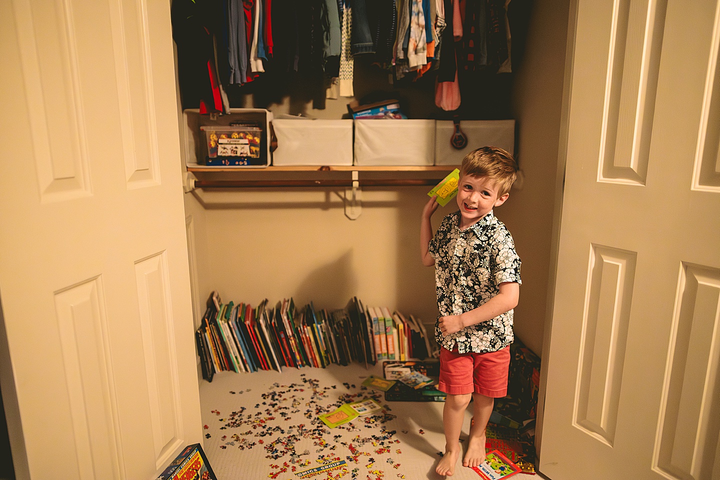 Boy running out of his closet holding a book