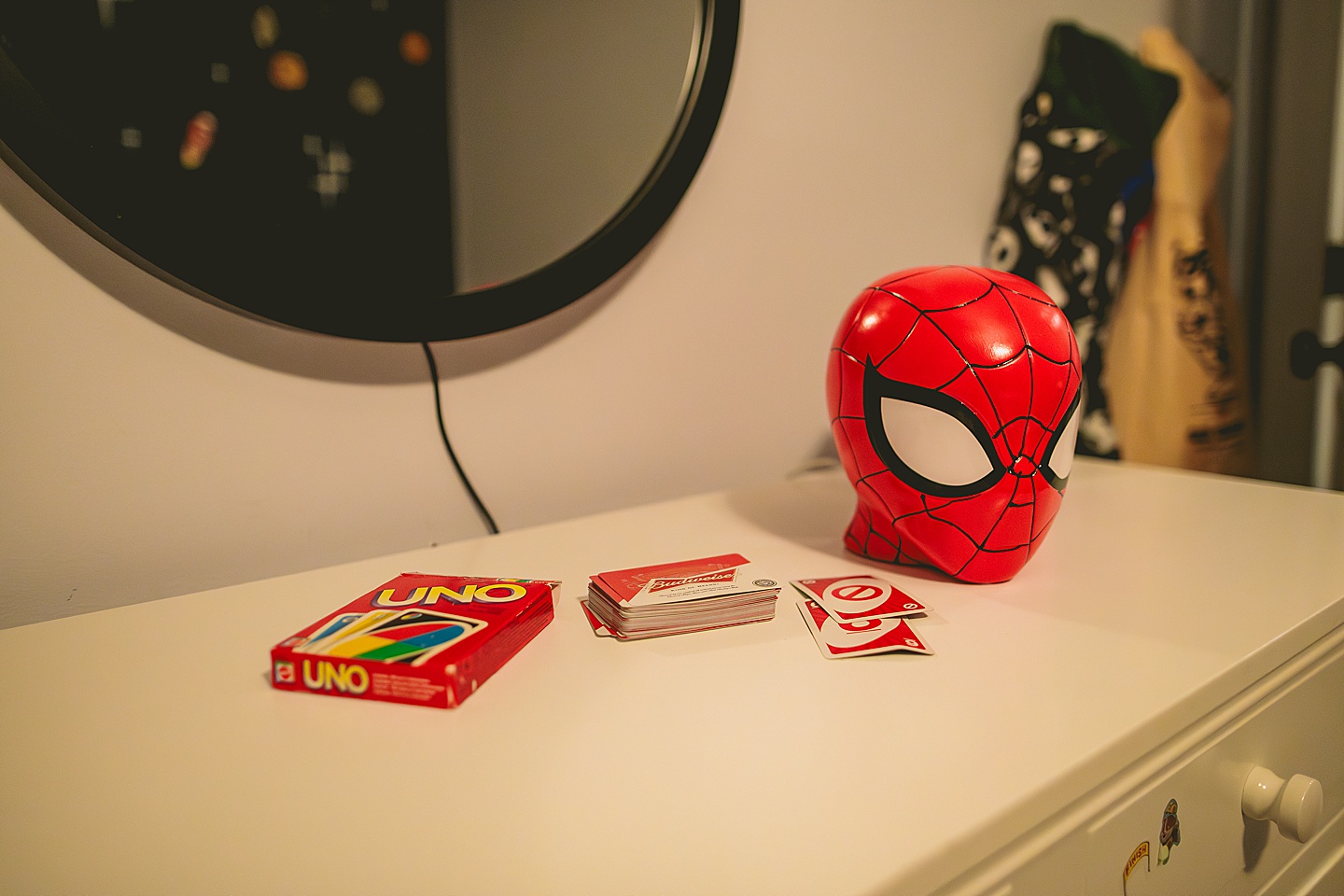 Spiderman head next to deck of Uno cards