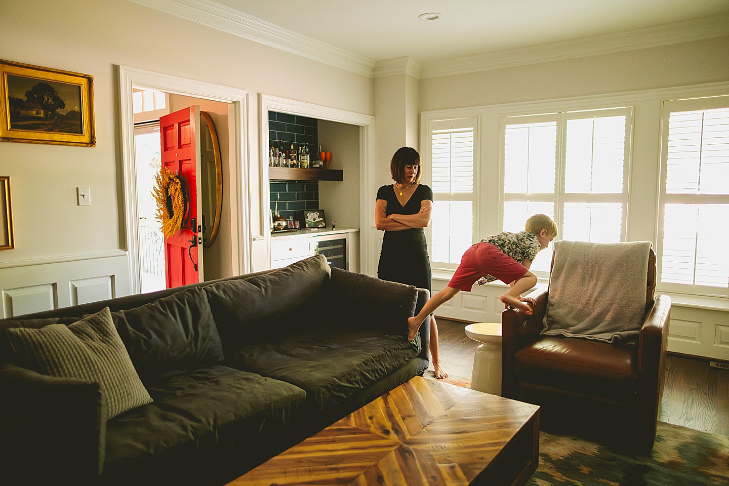 Boy jumping on living room furniture