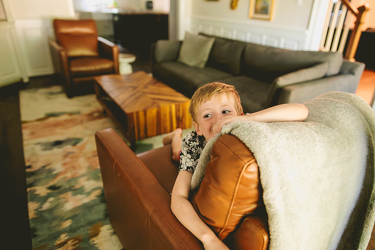 Boy jumping on living room furniture