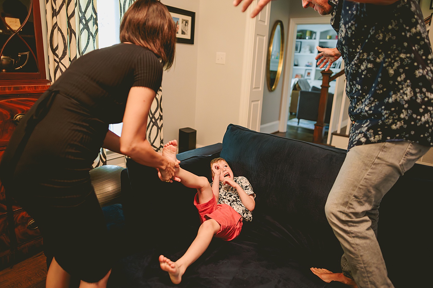 Kid goofing around with parents