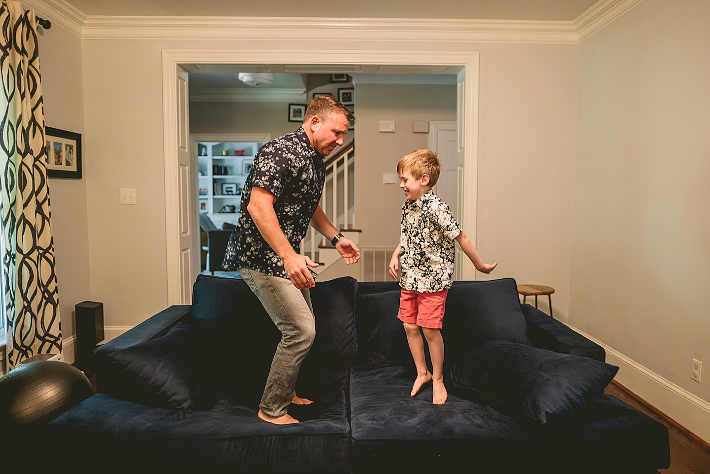 Dad playing with son on the couch