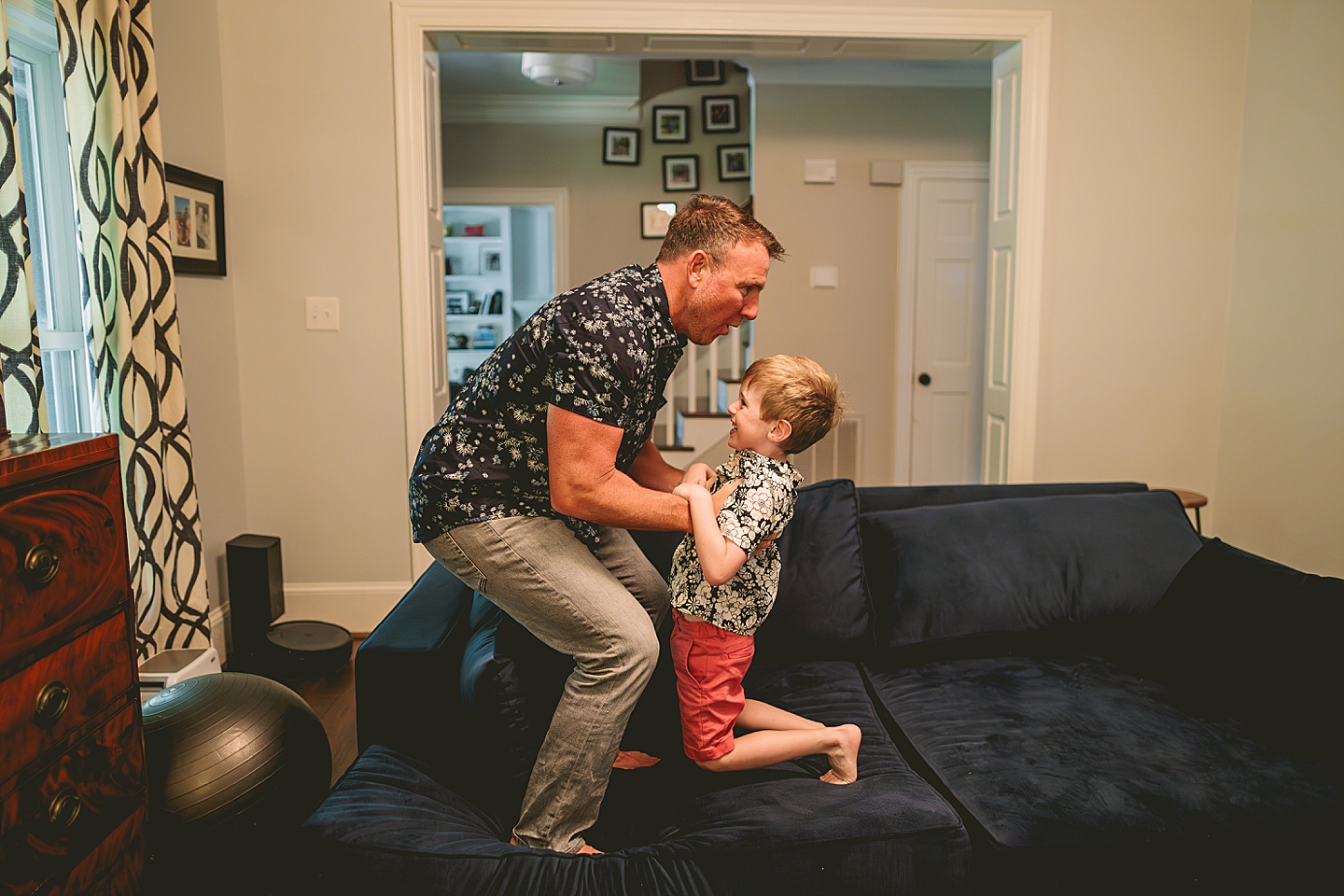 Dad playing with son on the couch