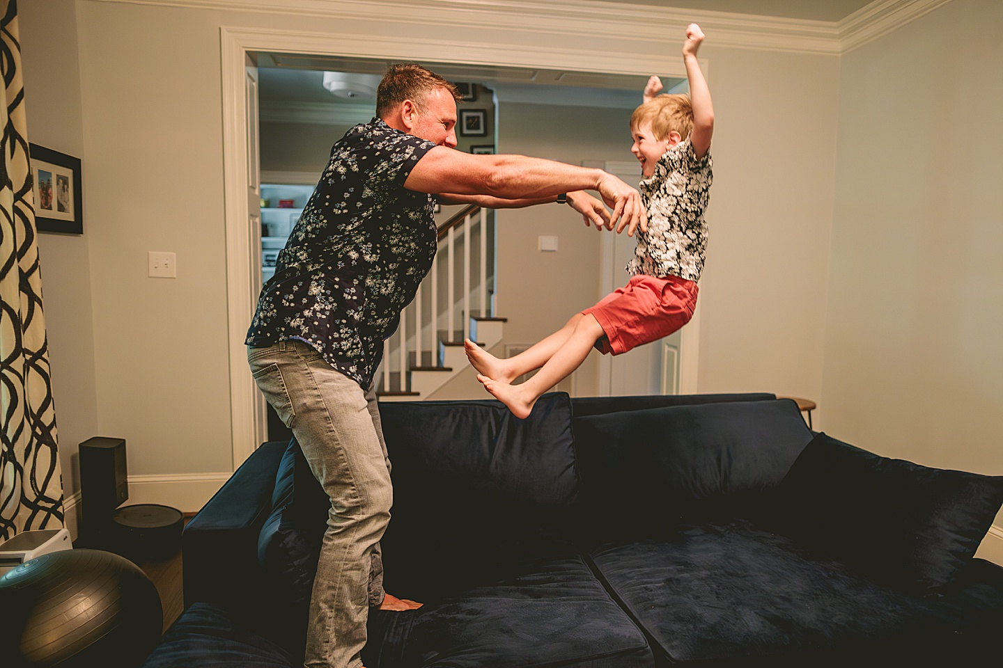 Dad playing with son on the couch