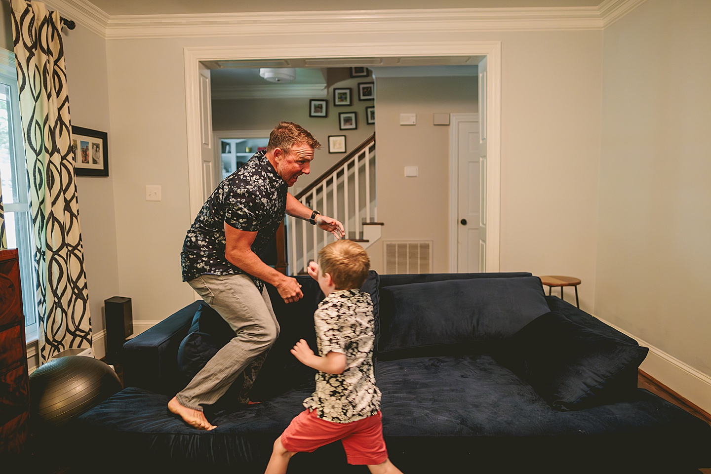 Dad playing with son on the couch