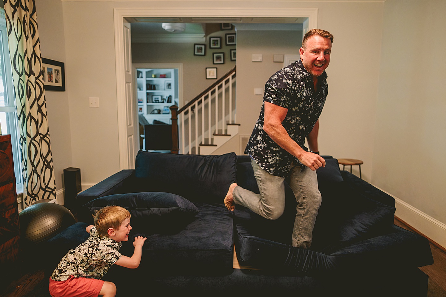 Dad playing with son on the couch