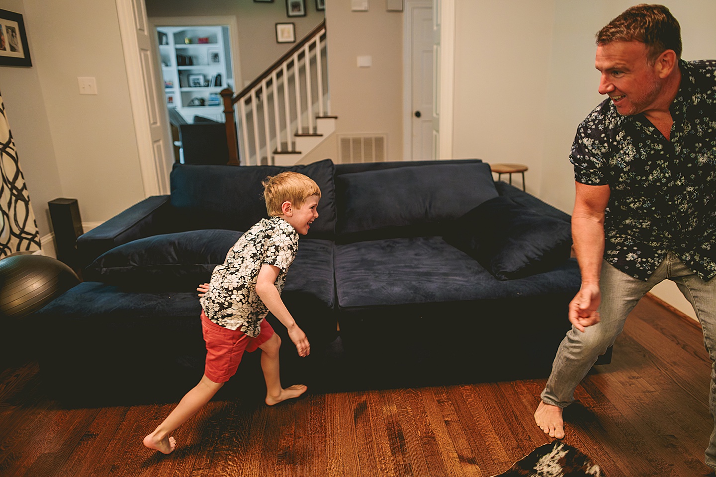 Dad playing with son on the couch