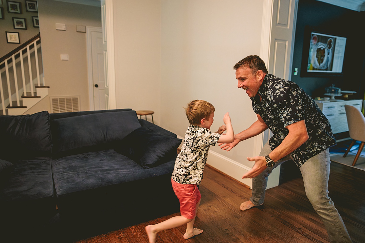 Dad playing with son on the couch