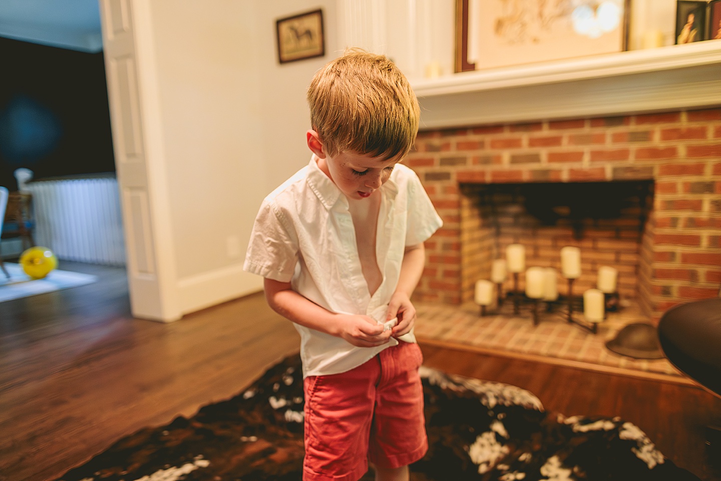 Kid buttoning a shirt