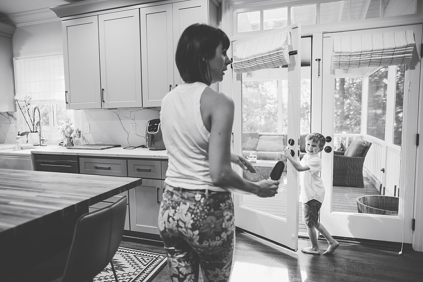 Mom carrying out popsicle for son