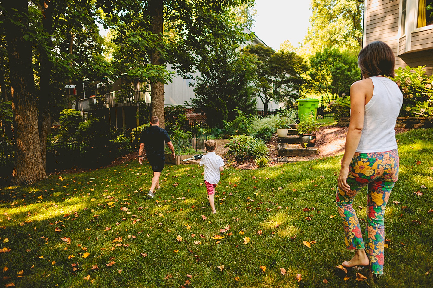 Kid walking around garden with parents