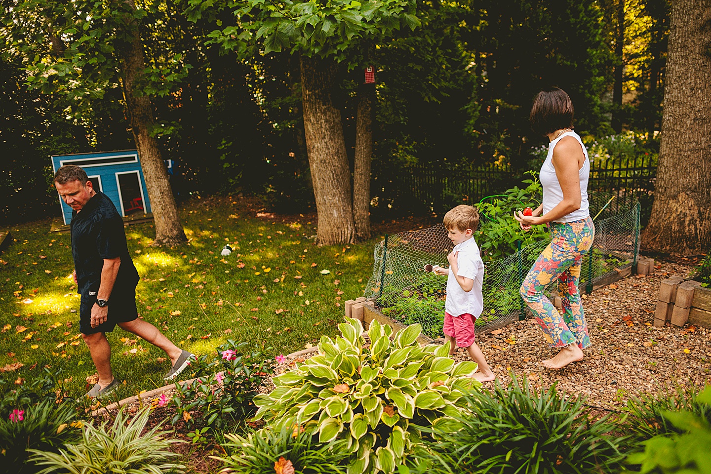 Kid walking around garden with parents