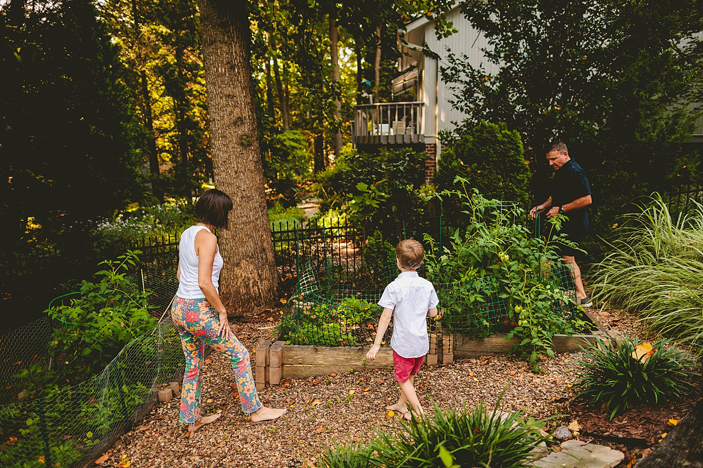 Kid walking around garden with parents