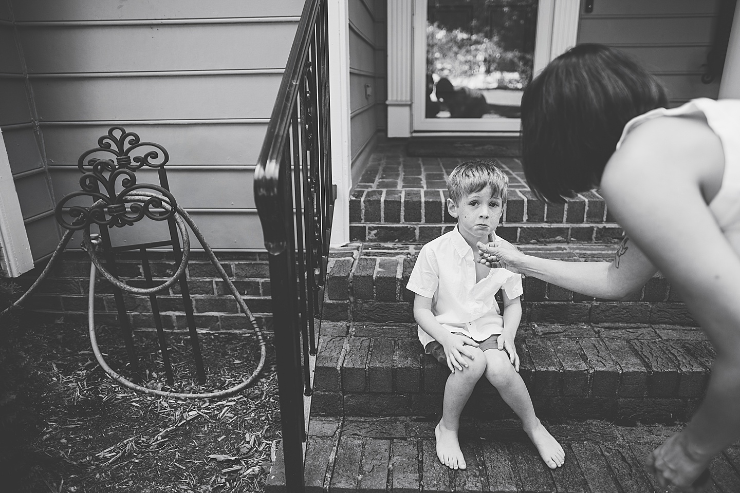 Kid sitting on porch steps