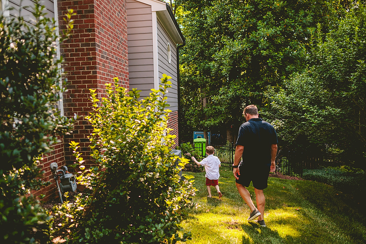 Kid walking around garden with parents