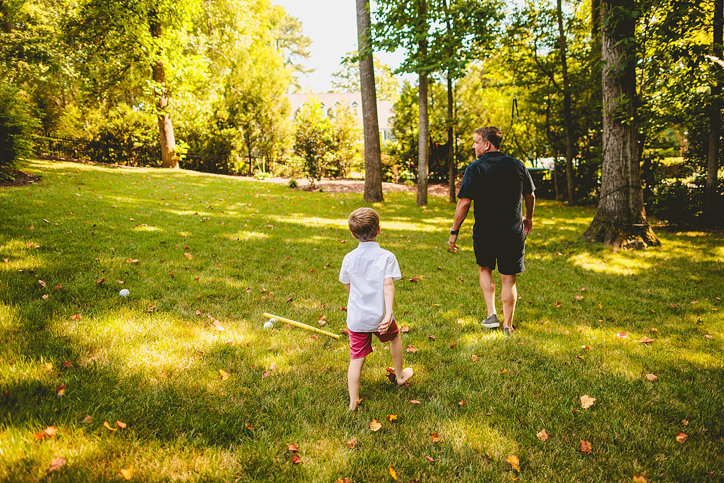 Kid following Dad around backyard