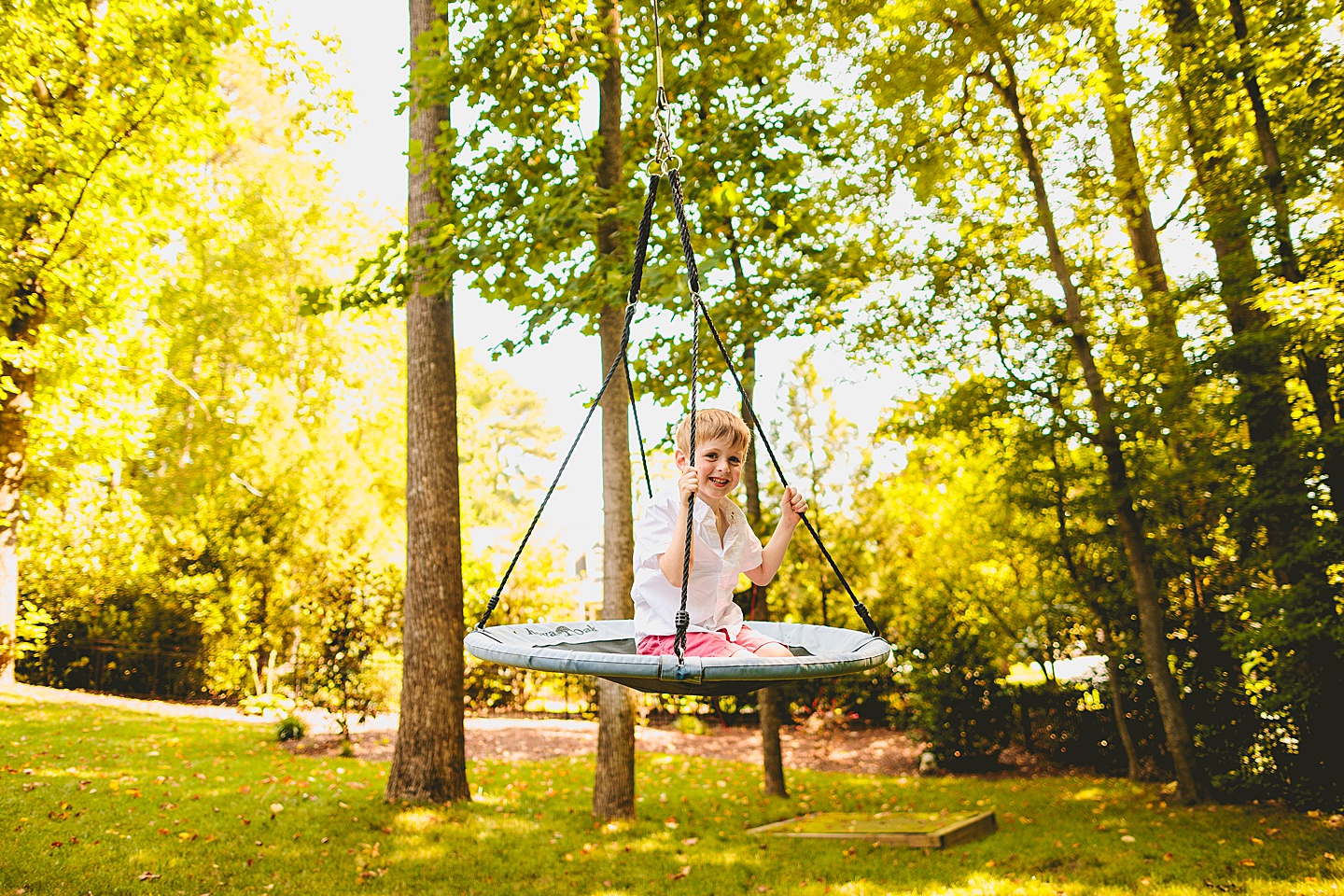 Kid swinging in backyard